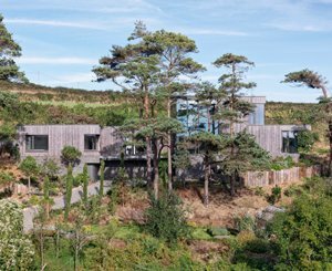A sustainable house and its Kebony timber façade rise amid the rugged Welsh coastline